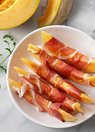 prosciutto and melon on a plate